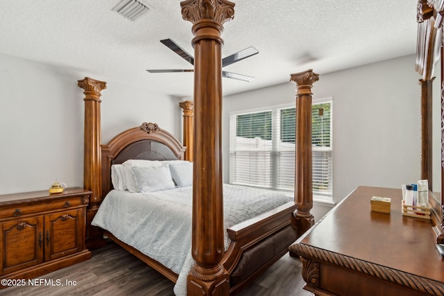 75652 Edwards Rd, Yulee, FL 32097 - bedroom with dark wood-style flooring, decorative columns, a textured ceiling, and ceiling fan