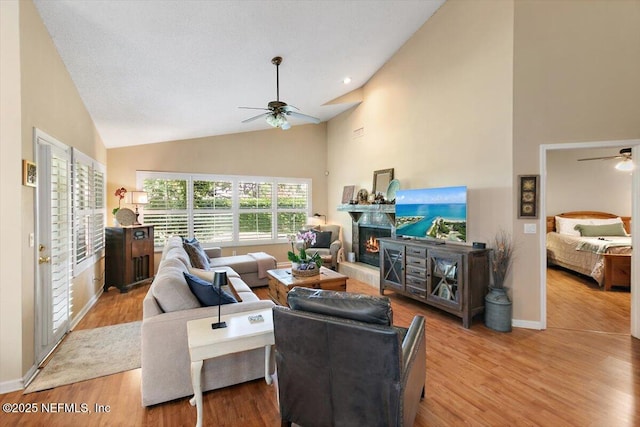 101 Duck Bill Cv, Ponte Vedra Beach, FL 32082 - living room with ceiling fan, a lit fireplace, high vaulted ceiling, and wood finished floors