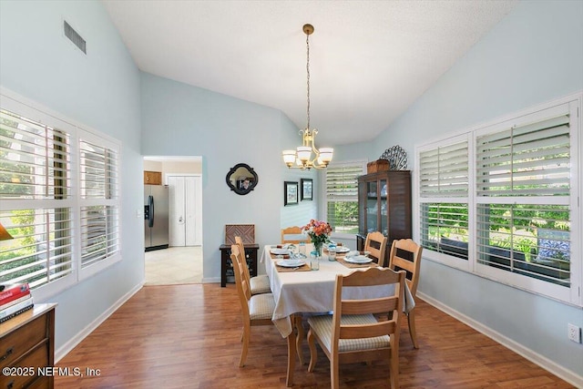 101 Duck Bill Cv, Ponte Vedra Beach, FL 32082 - dining area with lofted ceiling, a chandelier, and wood finished floors