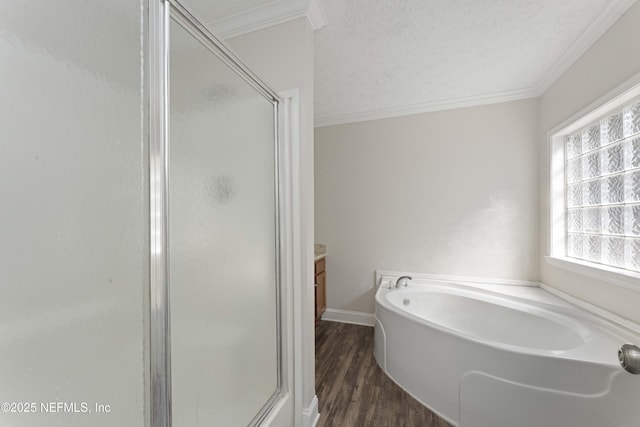 103 Chapin St, Saint Augustine, FL 32084 - full bathroom featuring a shower stall, ornamental molding, a garden tub, wood finished floors, and vanity