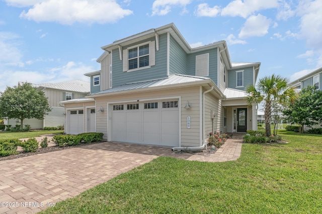 106 Rum Runner Way, Saint Johns, FL 32259 - view of front of house featuring decorative driveway, a front yard, an attached garage, and a metal roof