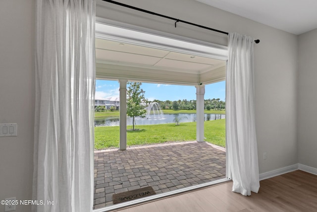 106 Rum Runner Way, Saint Johns, FL 32259 - doorway to outside featuring a water view, plenty of natural light, and wood finished floors