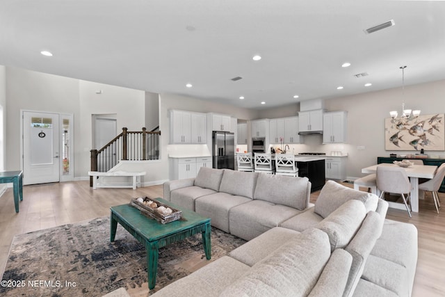 106 Rum Runner Way, Saint Johns, FL 32259 - living room with a chandelier, light wood-style flooring, recessed lighting, and stairs