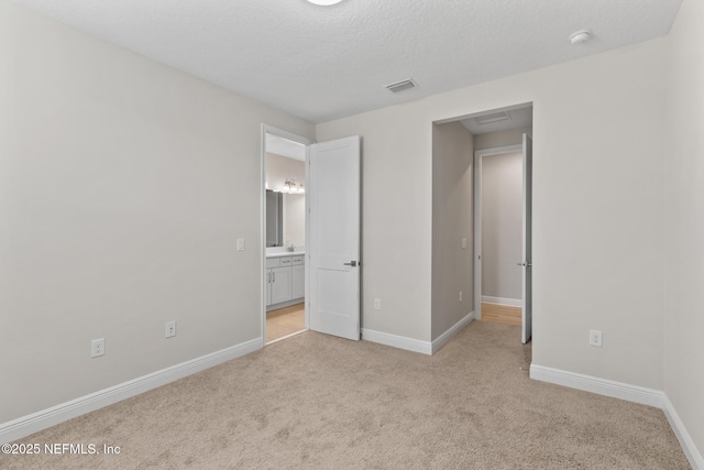 106 Rum Runner Way, Saint Johns, FL 32259 - unfurnished bedroom featuring light carpet, a textured ceiling, and connected bathroom