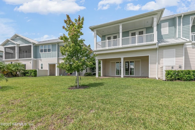 106 Rum Runner Way, Saint Johns, FL 32259 - back of house featuring a balcony, board and batten siding, and a yard