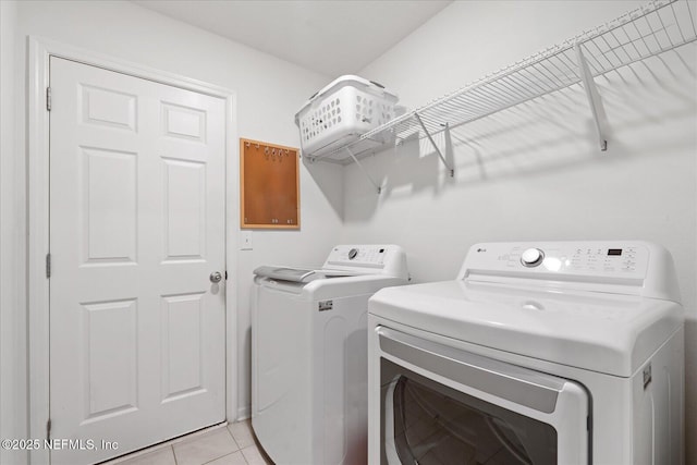 20 Willow St, Palm Coast, FL 32164 - washroom with washer and clothes dryer and light tile patterned floors