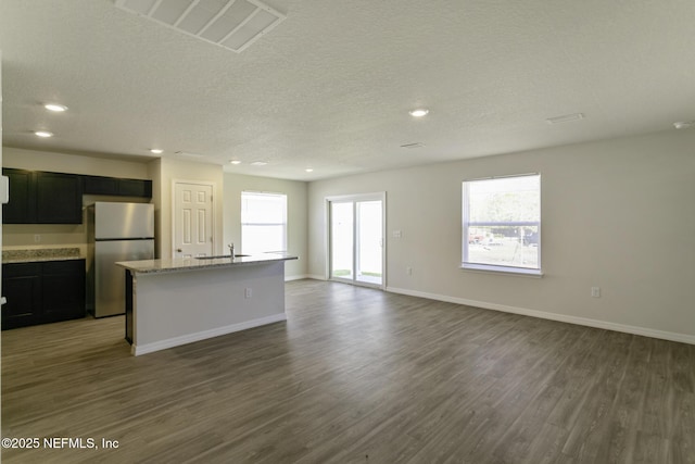 3 Ryecast Pl, Palm Coast, FL 32164 - unfurnished living room featuring dark wood-type flooring, recessed lighting, and a textured ceiling