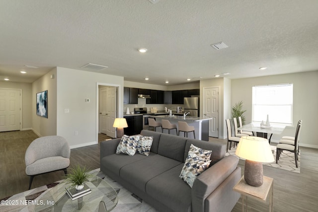 3 Ryecast Pl, Palm Coast, FL 32164 - living room featuring light wood-type flooring, recessed lighting, and a textured ceiling