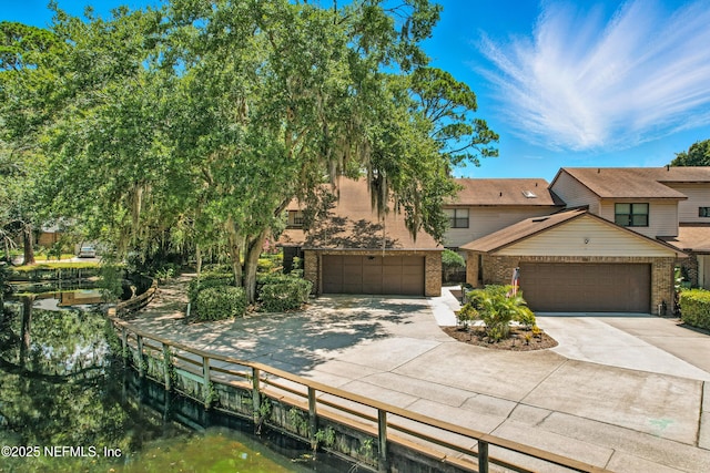 4251 Monument Rd Unit 805, Jacksonville, FL 32225 - view of front of home featuring concrete driveway, a garage, and brick siding