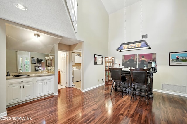 4251 Monument Rd Unit 805, Jacksonville, FL 32225 - dining area with high vaulted ceiling, wood finished floors, and washer / dryer