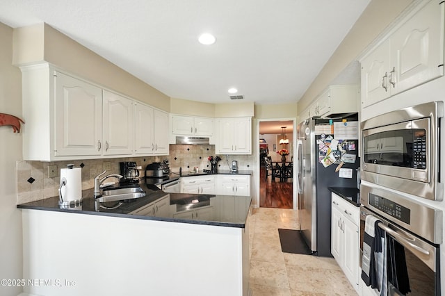 4251 Monument Rd Unit 805, Jacksonville, FL 32225 - kitchen with stainless steel appliances, dark countertops, a peninsula, decorative backsplash, and recessed lighting