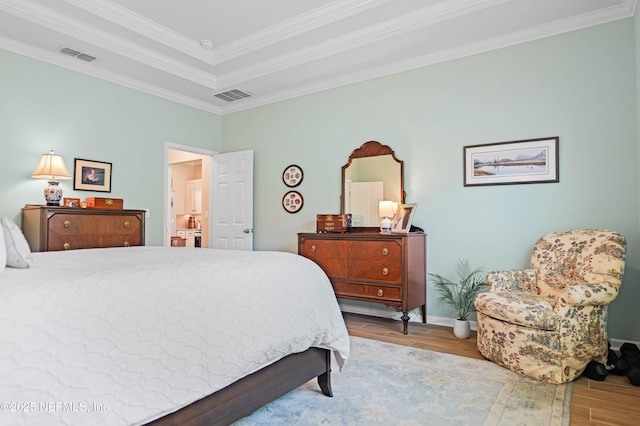 96740 Quartz Ln, Yulee, FL 32097 - bedroom with wood finished floors, ornamental molding, a tray ceiling, and connected bathroom