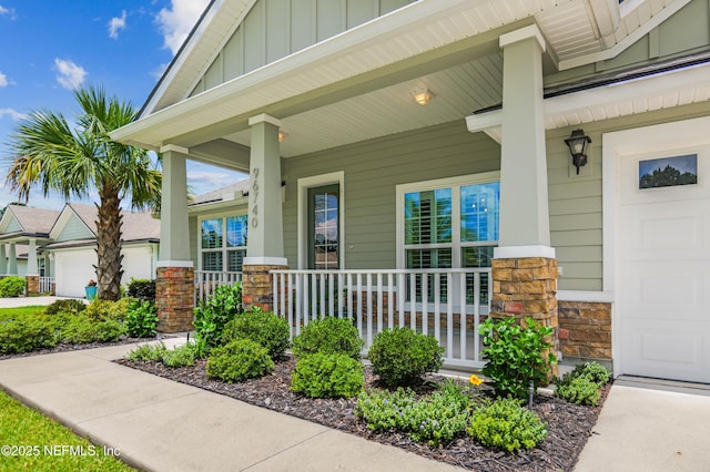 96740 Quartz Ln, Yulee, FL 32097 - entrance to property with covered porch, stone siding, board and batten siding, and a garage