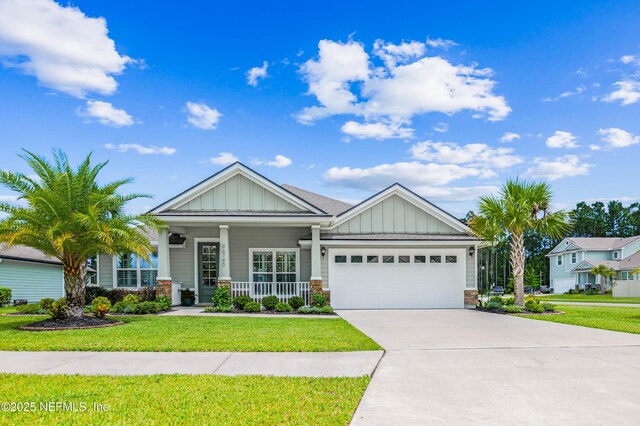 96740 Quartz Ln, Yulee, FL 32097 - craftsman-style home featuring board and batten siding, covered porch, an attached garage, and a front yard
