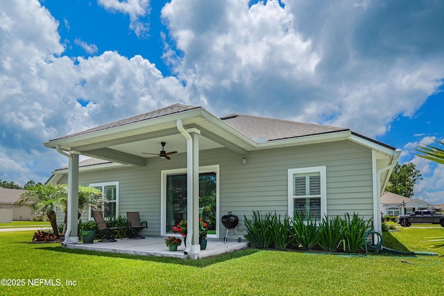 96740 Quartz Ln, Yulee, FL 32097 - rear view of property featuring a ceiling fan, a patio, a lawn, and roof with shingles