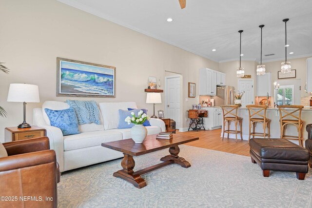 96740 Quartz Ln, Yulee, FL 32097 - living room featuring light wood-type flooring, crown molding, a chandelier, and recessed lighting