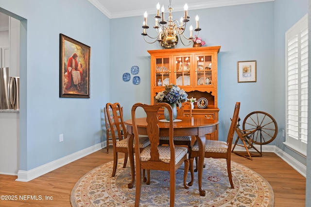 96740 Quartz Ln, Yulee, FL 32097 - dining space with a chandelier, light wood-style floors, and crown molding