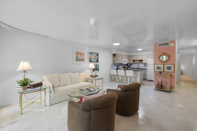 1071 Edgewood Ave S Unit 407, Jacksonville, FL 32205 - living room with finished concrete flooring and baseboards