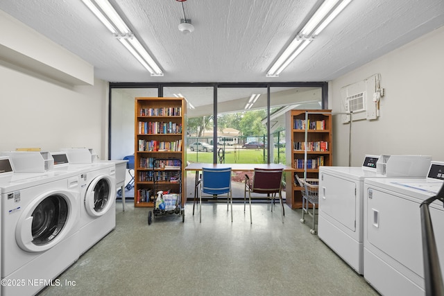 1071 Edgewood Ave S Unit 407, Jacksonville, FL 32205 - community laundry featuring washing machine and dryer, an AC wall unit, and a textured ceiling