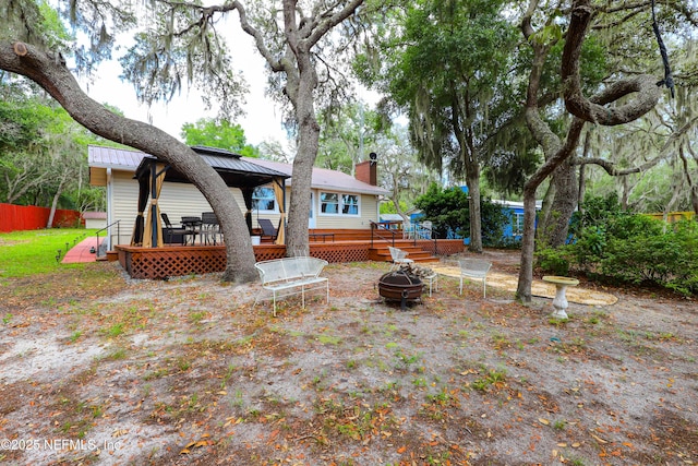 5299 County Road 352nd Rd, Keystone Heights, FL 32656 - rear view of property with a fire pit, a deck, a metal roof, a chimney, and a gazebo