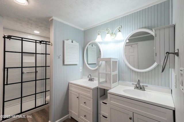 5299 County Road 352nd Rd, Keystone Heights, FL 32656 - full bath with a textured ceiling, two vanities, wood finished floors, crown molding, and wallpapered walls
