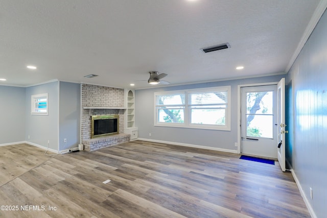 5299 County Road 352nd Rd, Keystone Heights, FL 32656 - unfurnished living room with ornamental molding, a ceiling fan, wood finished floors, recessed lighting, and a fireplace