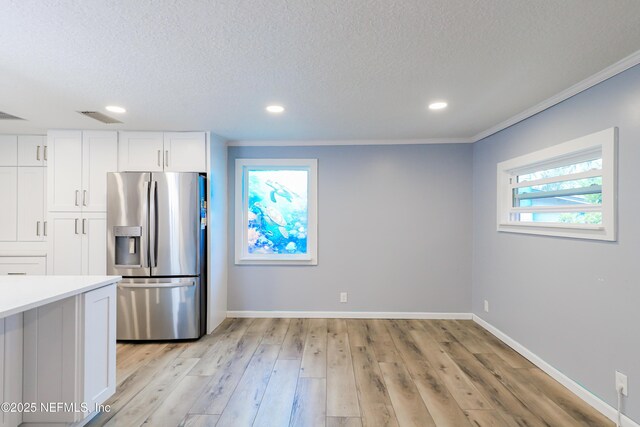 5299 County Road 352nd Rd, Keystone Heights, FL 32656 - kitchen with stainless steel refrigerator with ice dispenser, a textured ceiling, white cabinets, recessed lighting, and light countertops