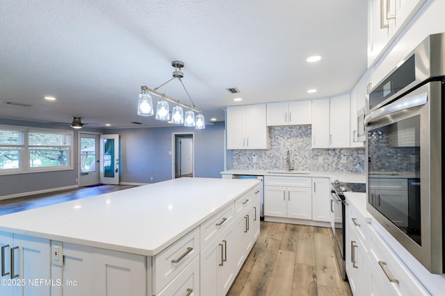 5299 County Road 352nd Rd, Keystone Heights, FL 32656 - kitchen with oven, dishwashing machine, electric stove, light wood finished floors, and light countertops