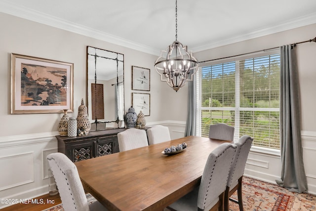 1805 Commodore Point Dr, Fleming Island, FL 32003 - dining space with a chandelier, crown molding, wood finished floors, wainscoting, and a decorative wall