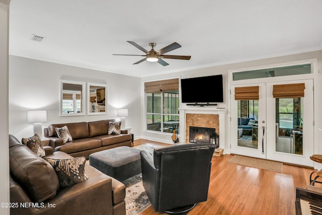 1805 Commodore Point Dr, Fleming Island, FL 32003 - living room featuring ornamental molding, ceiling fan, wood finished floors, french doors, and a tiled fireplace