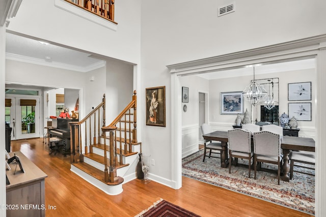 1805 Commodore Point Dr, Fleming Island, FL 32003 - dining area with wood finished floors, crown molding, stairway, and a chandelier