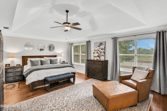 1805 Commodore Point Dr, Fleming Island, FL 32003 - bedroom with wood finished floors, a tray ceiling, crown molding, and a ceiling fan