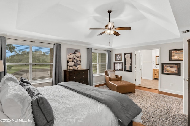 1805 Commodore Point Dr, Fleming Island, FL 32003 - bedroom featuring a raised ceiling, wood finished floors, ornamental molding, ensuite bathroom, and ceiling fan