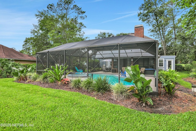 1805 Commodore Point Dr, Fleming Island, FL 32003 - rear view of house with a yard, a chimney, a patio, glass enclosure, and a pool with connected hot tub