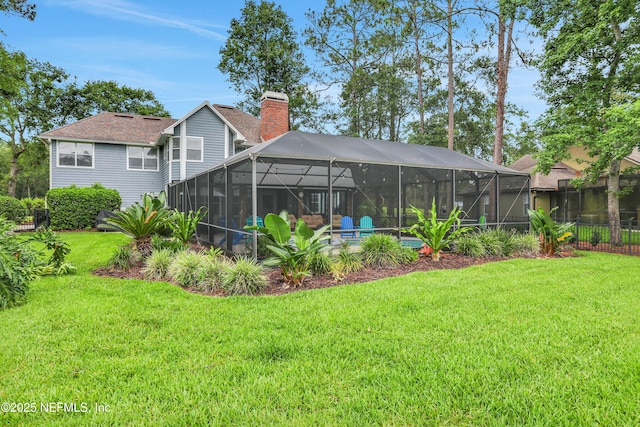 1805 Commodore Point Dr, Fleming Island, FL 32003 - back of house featuring a chimney, a lawn, a swimming pool, glass enclosure, and roof with shingles