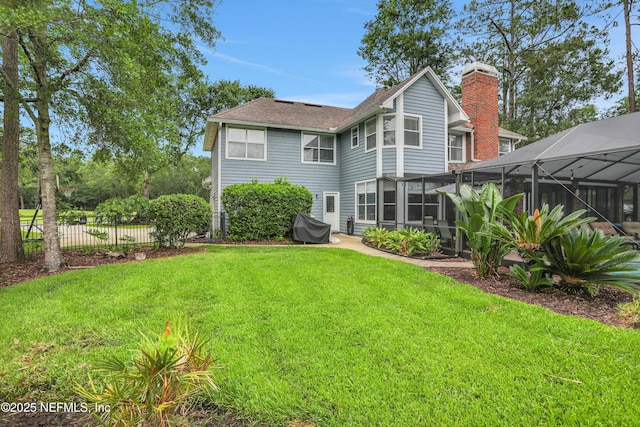1805 Commodore Point Dr, Fleming Island, FL 32003 - rear view of property with a chimney, glass enclosure, and roof with shingles