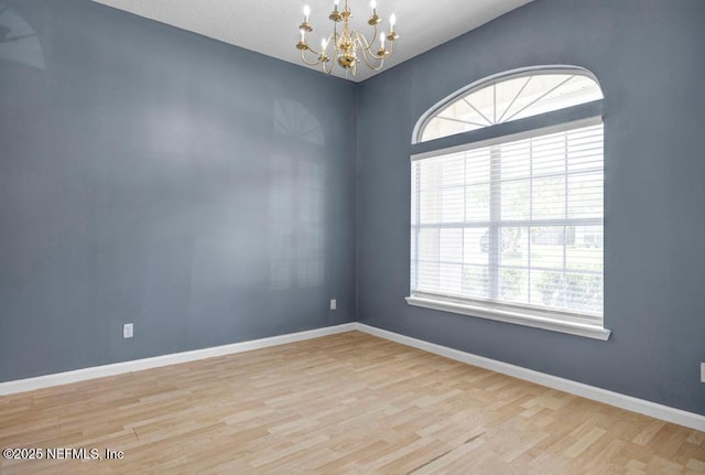 1069 Ardmore St, Saint Augustine, FL 32092 - empty room featuring a chandelier, plenty of natural light, and wood finished floors