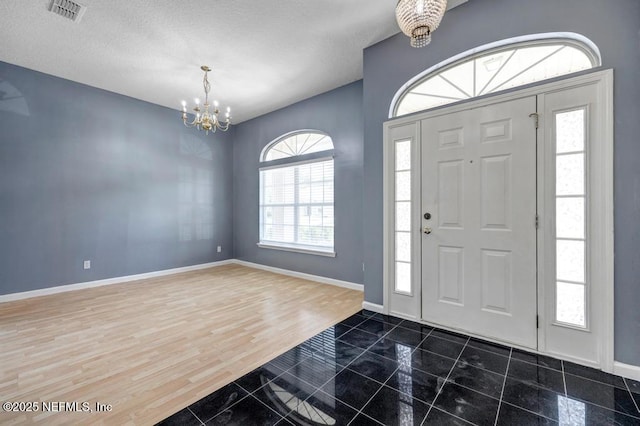 1069 Ardmore St, Saint Augustine, FL 32092 - foyer with a chandelier, a textured ceiling, and wood finished floors