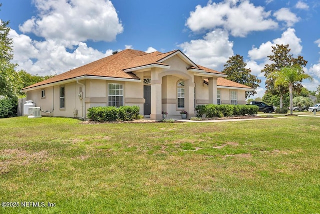 1069 Ardmore St, Saint Augustine, FL 32092 - view of front of house with stucco siding, a front yard, and roof with shingles