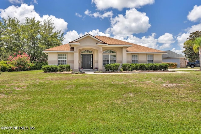 1069 Ardmore St, Saint Augustine, FL 32092 - view of front facade with stucco siding and a front lawn