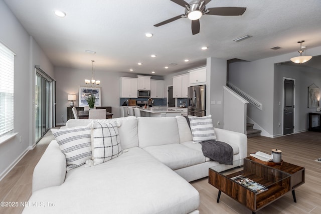 21 Vicksburg Dr, Saint Johns, FL 32259 - living area featuring ceiling fan, stairway, light wood-style flooring, recessed lighting, and a chandelier