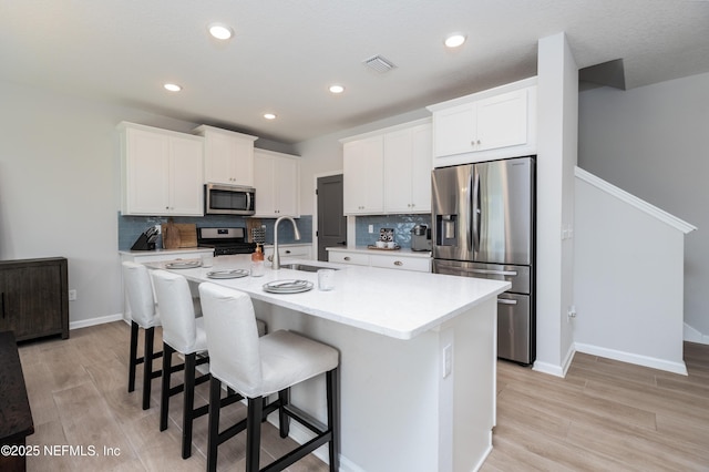 21 Vicksburg Dr, Saint Johns, FL 32259 - kitchen featuring appliances with stainless steel finishes, light wood-type flooring, backsplash, and recessed lighting