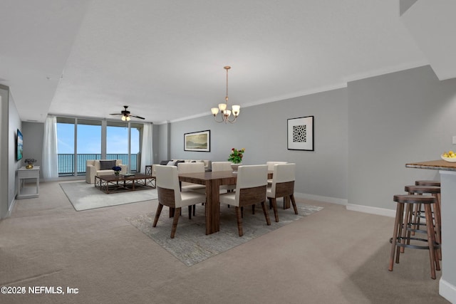 1031 1st St S Unit 504, Jacksonville Beach, FL 32250 - dining room featuring carpet flooring, a chandelier, ceiling fan, and crown molding