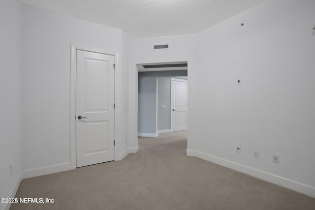 1031 1st St S Unit 504, Jacksonville Beach, FL 32250 - spare room featuring carpet floors and a textured ceiling