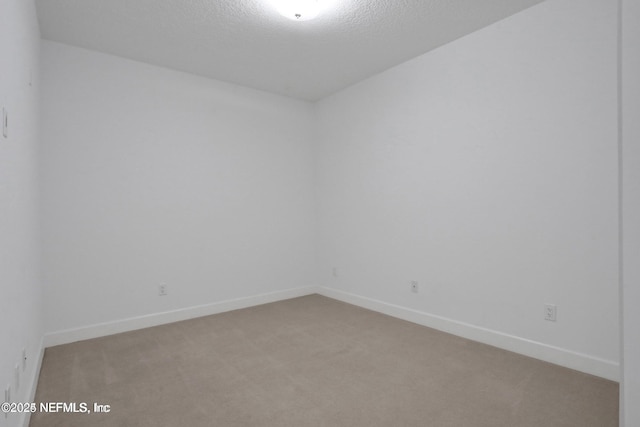 1031 1st St S Unit 504, Jacksonville Beach, FL 32250 - carpeted spare room featuring baseboards and a textured ceiling