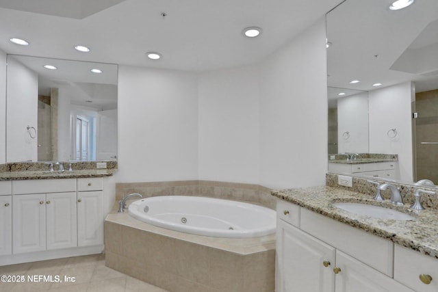 1031 1st St S Unit 504, Jacksonville Beach, FL 32250 - bathroom with a jetted tub, two vanities, recessed lighting, tile patterned flooring, and a shower stall