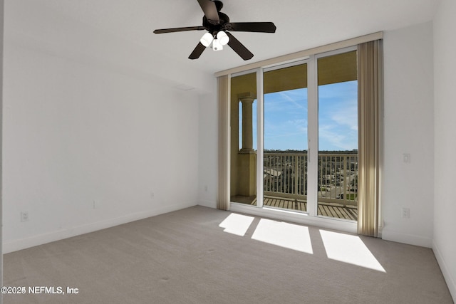 1031 1st St S Unit 504, Jacksonville Beach, FL 32250 - carpeted empty room featuring a wall of windows and a ceiling fan