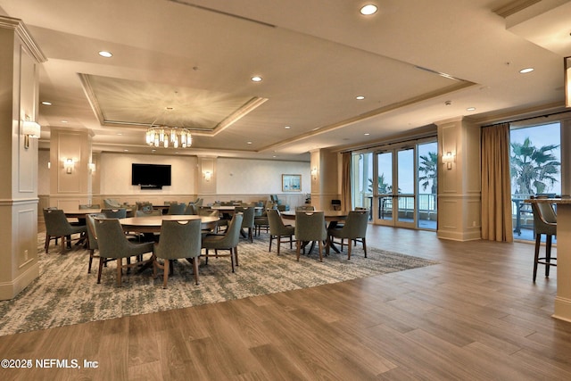 1031 1st St S Unit 504, Jacksonville Beach, FL 32250 - dining room with a raised ceiling, a decorative wall, plenty of natural light, wood finished floors, and recessed lighting