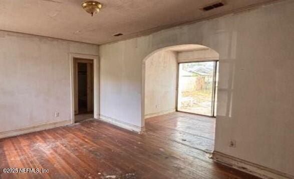625 W 46th St, Jacksonville, FL 32208 - spare room featuring arched walkways and hardwood / wood-style flooring