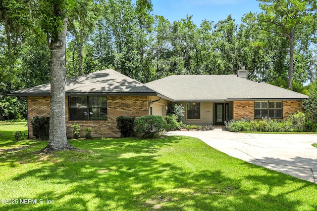 726 Arran Ct, Orange Park, FL 32073 - single story home with a chimney, a garage, concrete driveway, and brick siding
